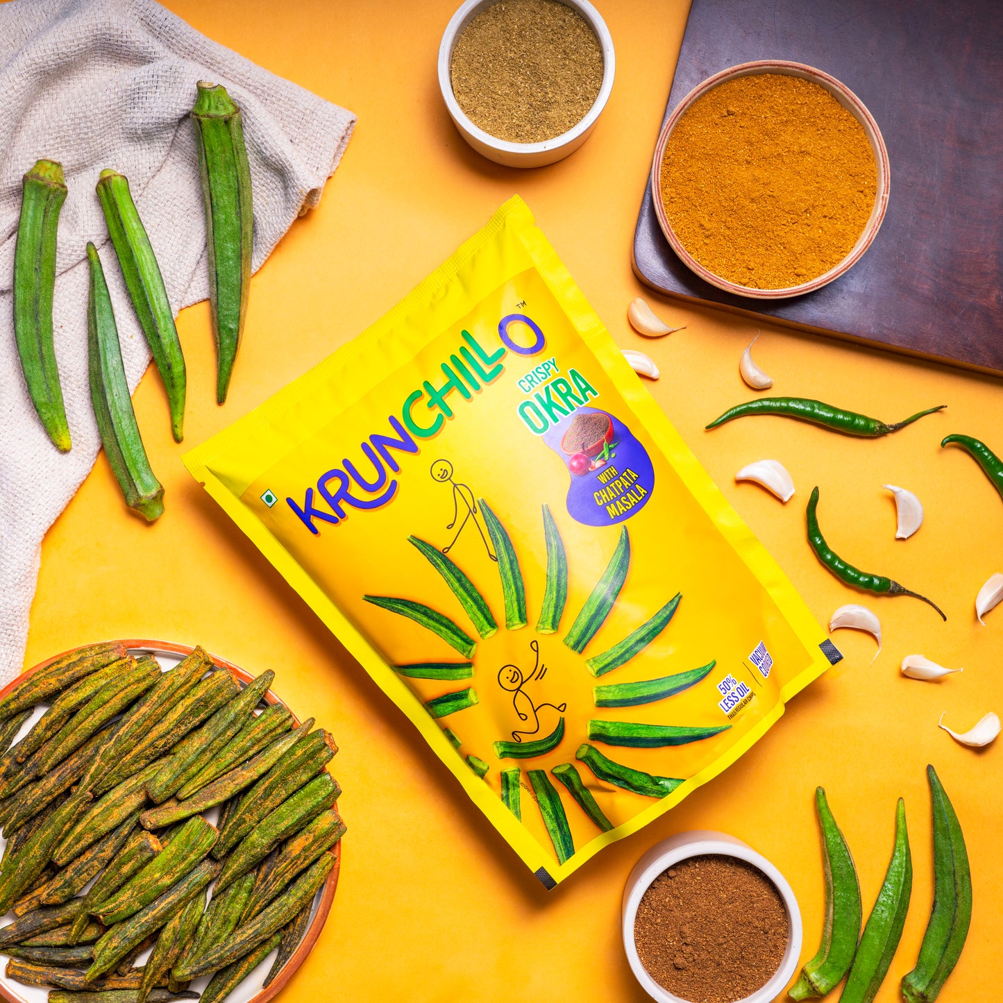 Krunchillo okra packaging with okra and spices on a yellow background