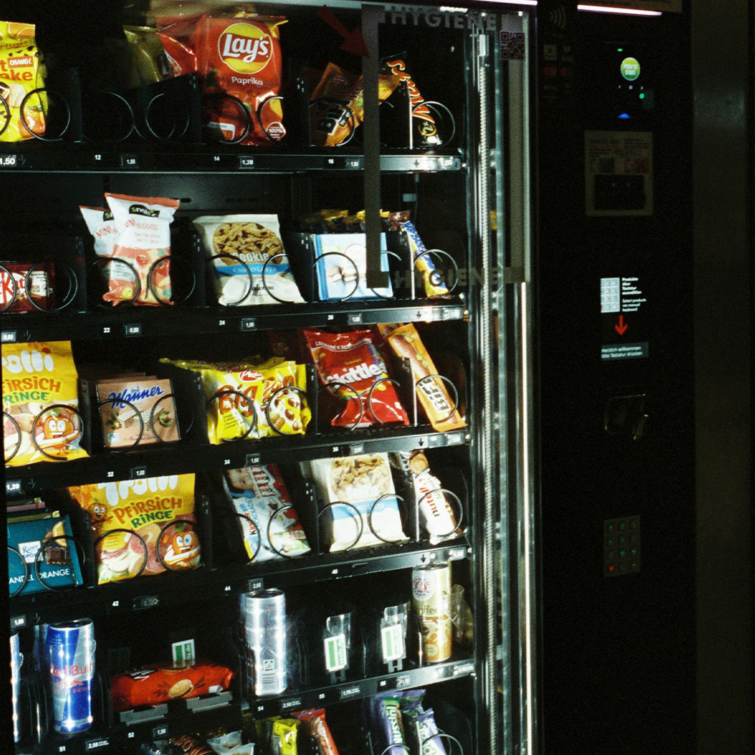 Vending machine stocked with various snacks and drinks